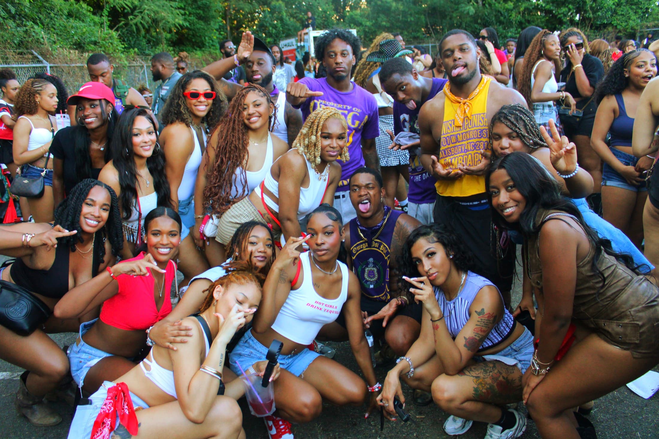 Large group of guests posing together at an outdoor social event