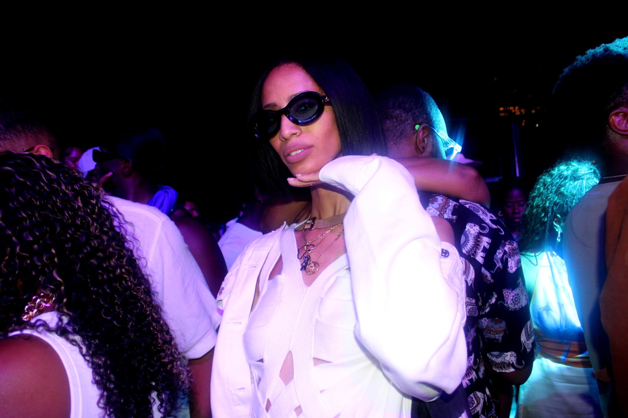 Nightlife portrait at a club with blue and purple ambient lighting